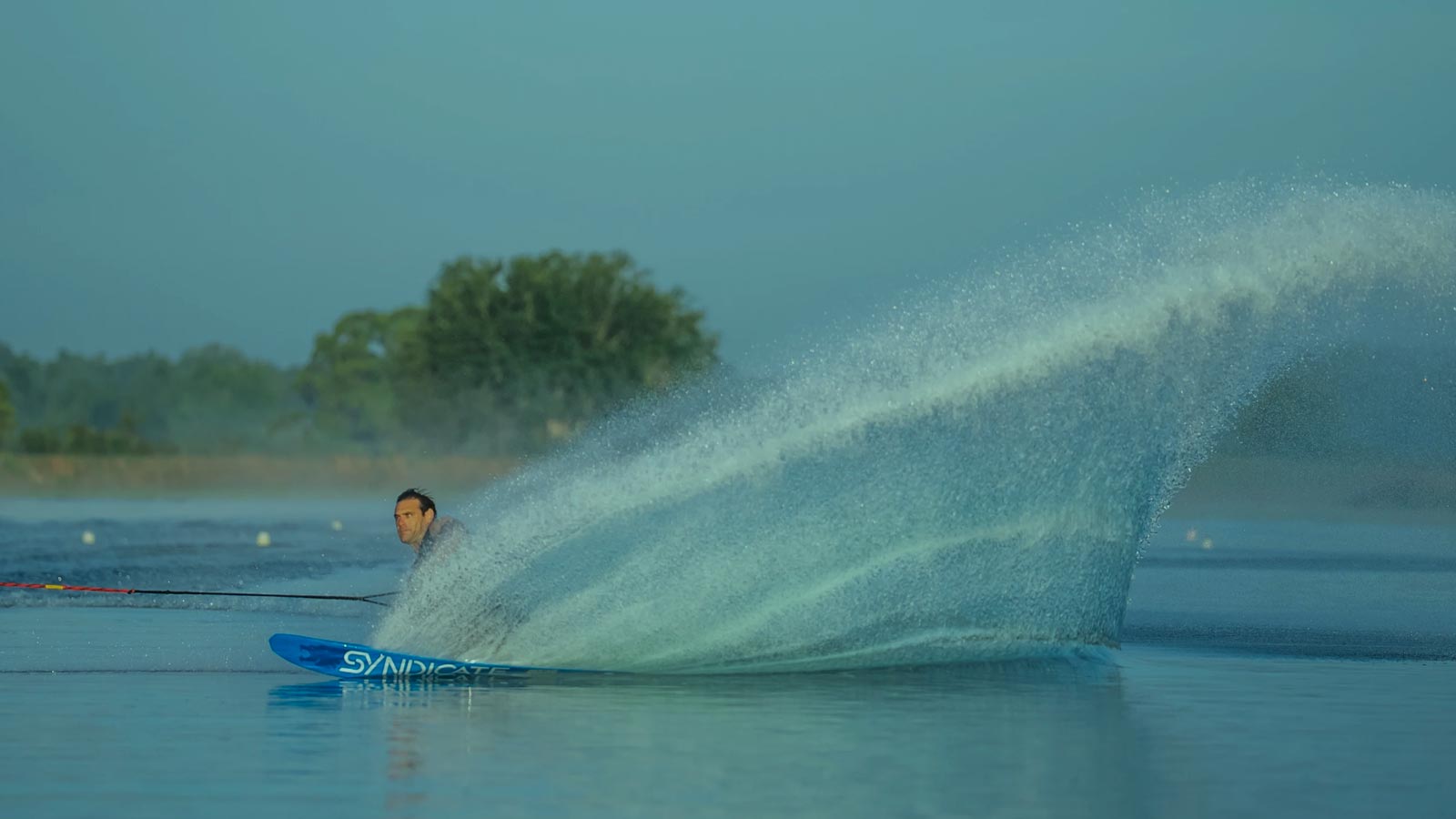 HO Sports Water Skier Making a Powerful Turn Across Glassy Water