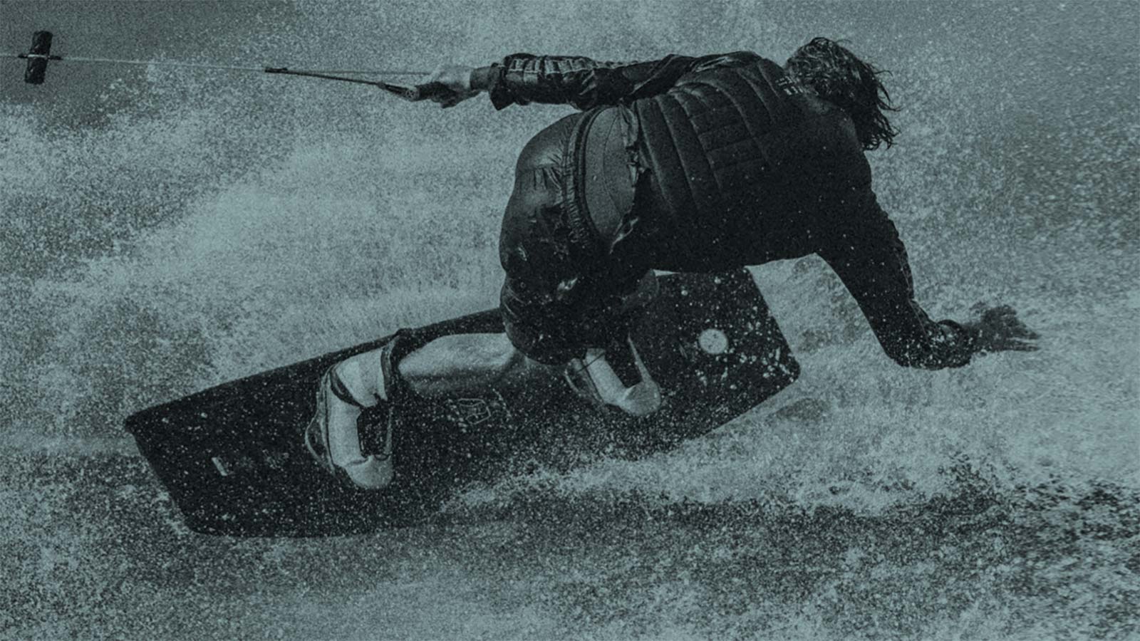 Hyperlite Wakeboard Rider Carving Through Heavy Water Spray
