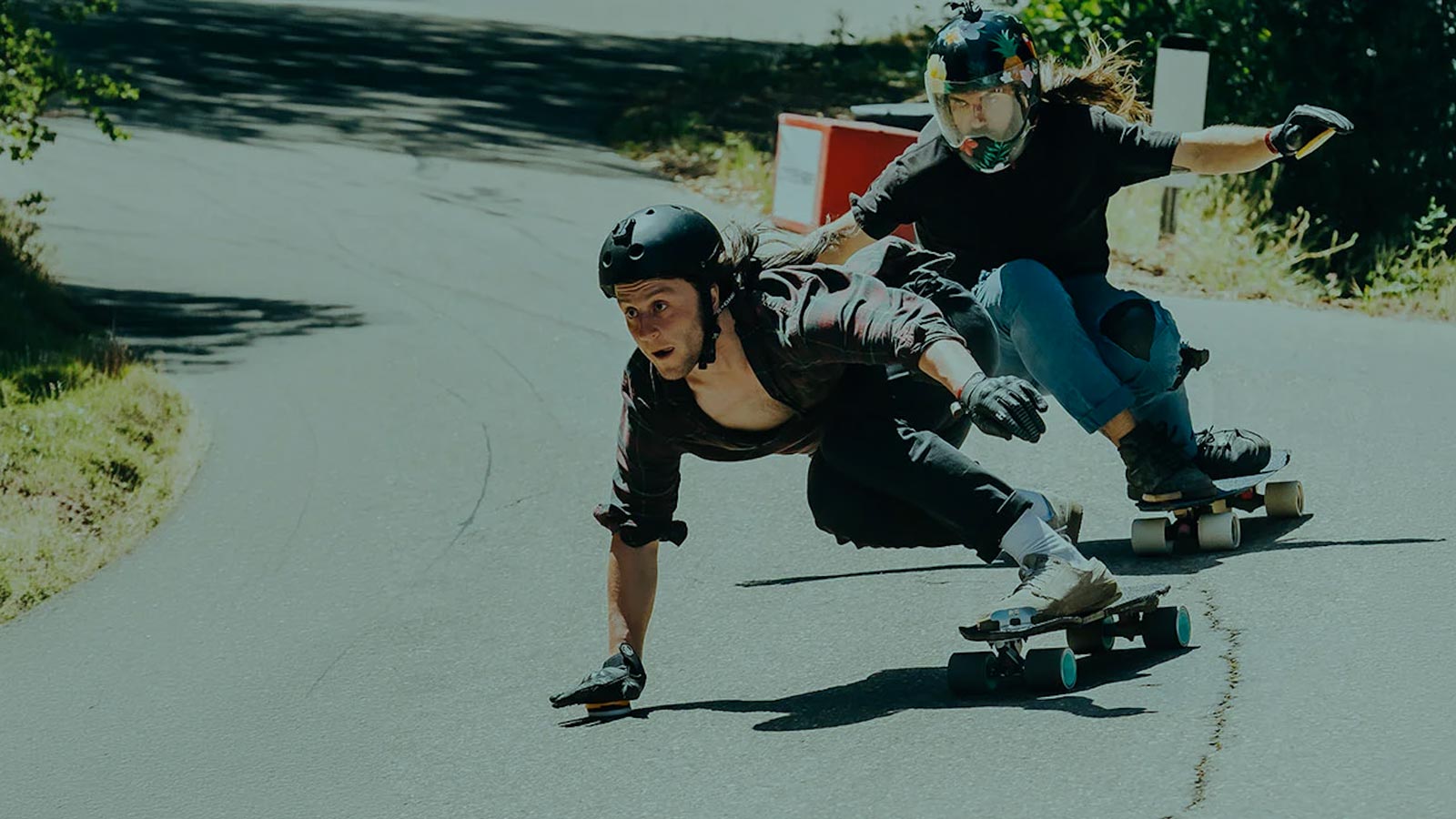 Landyachtz Longboard Riders Carving Downhill on a Mountain Road