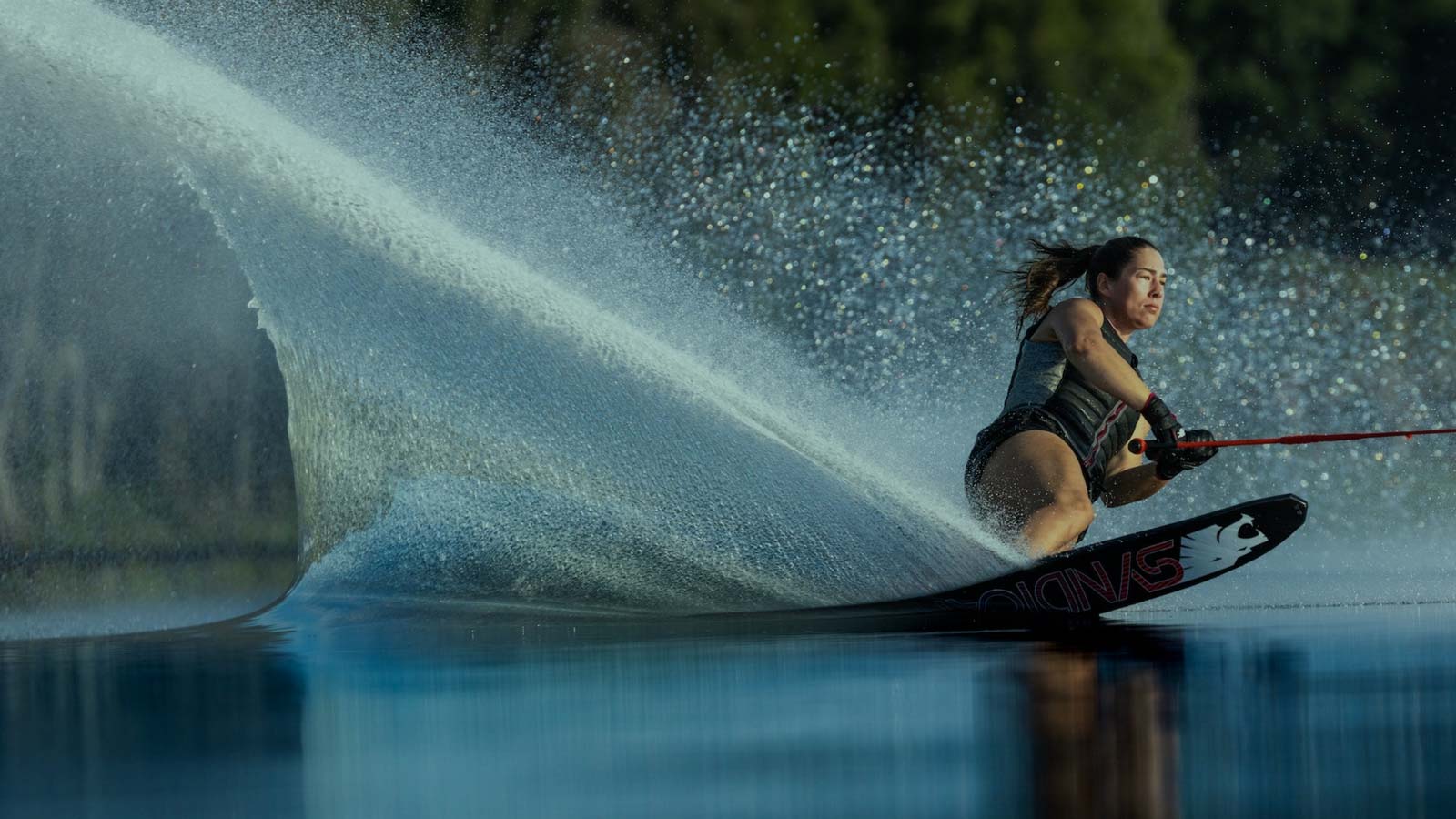Female Athlete Waterskiing. Water skis are a timeless classic of tow sports — pure speed, clean lines, and that unmistakable spray behind the boat.