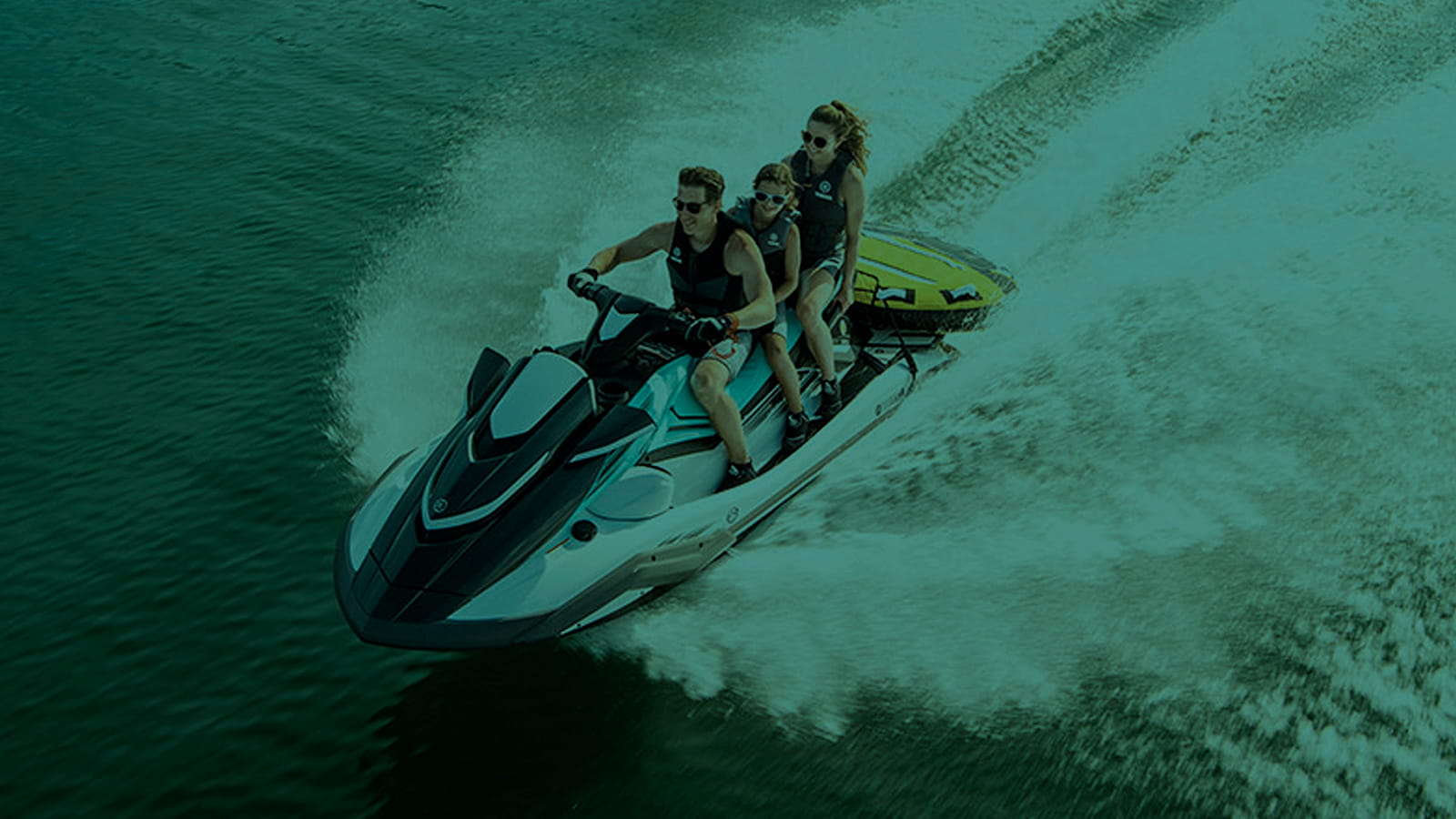 Jet Ski speeding ower the flkat water. Family Fun. Sunny Day. Life vests. Safety never takes the break..