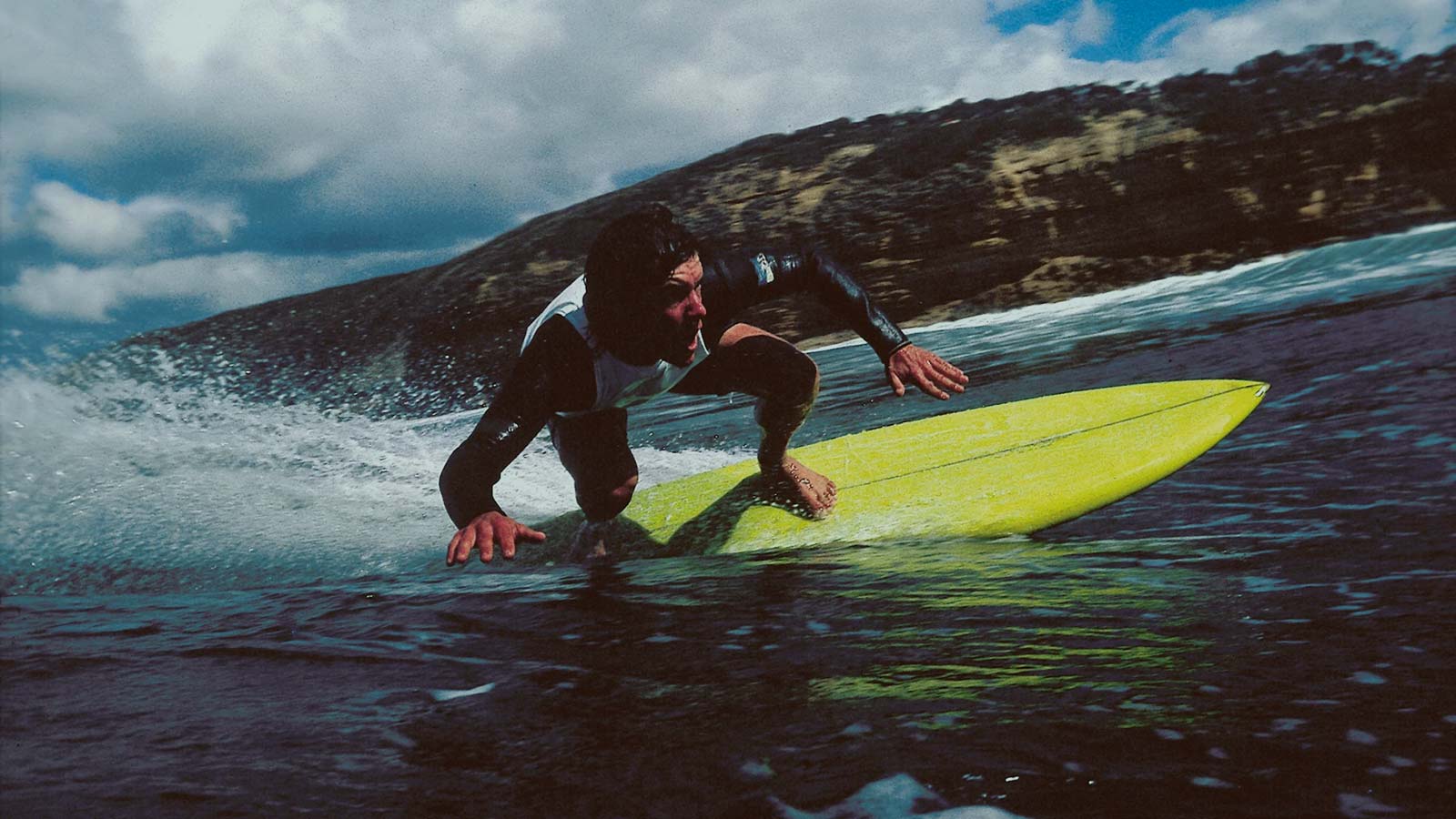 Ocean & Earth Surfer Riding a Wave in Cold Water Conditions
