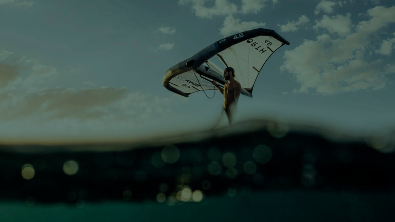 Wing Accsessoriels. Surf hats, leashes, spare parts, dry bags. Wingsurfer catching wind. 